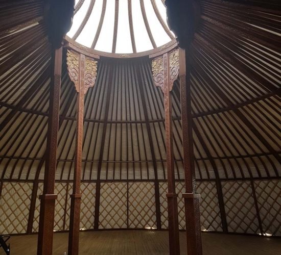 Brown yurt inside crown and pools